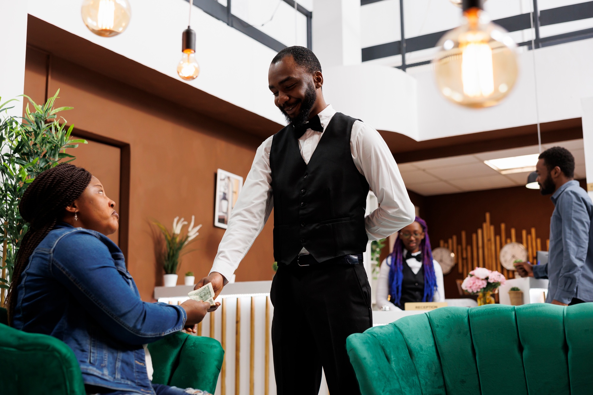 Generous hotel guest giving cash tip